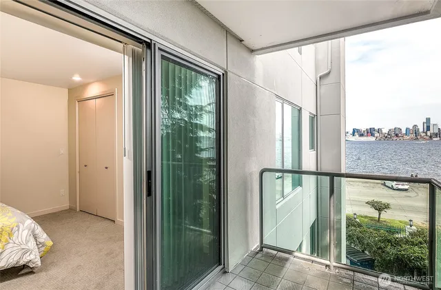 a living room with furniture a fireplace and a floor to ceiling window