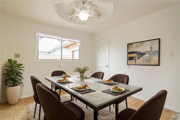 a dining room with furniture and window