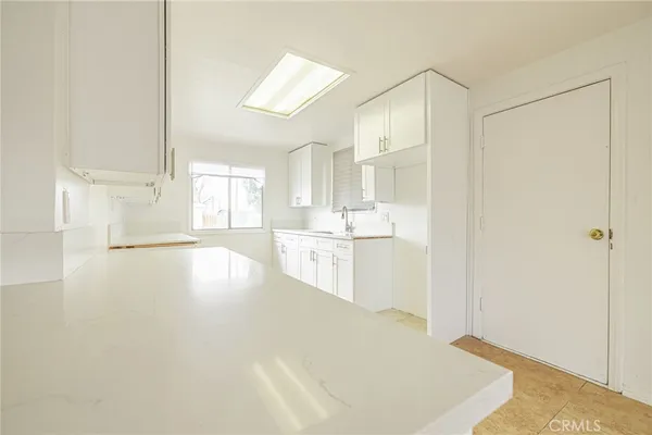 a view of a kitchen cabinets and wooden floor