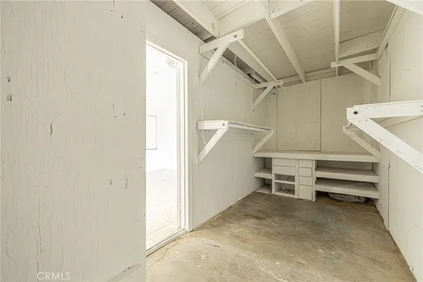 a view of a hallway with white walls and door