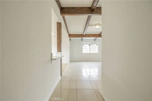 a view of a livingroom with wooden floor and windows