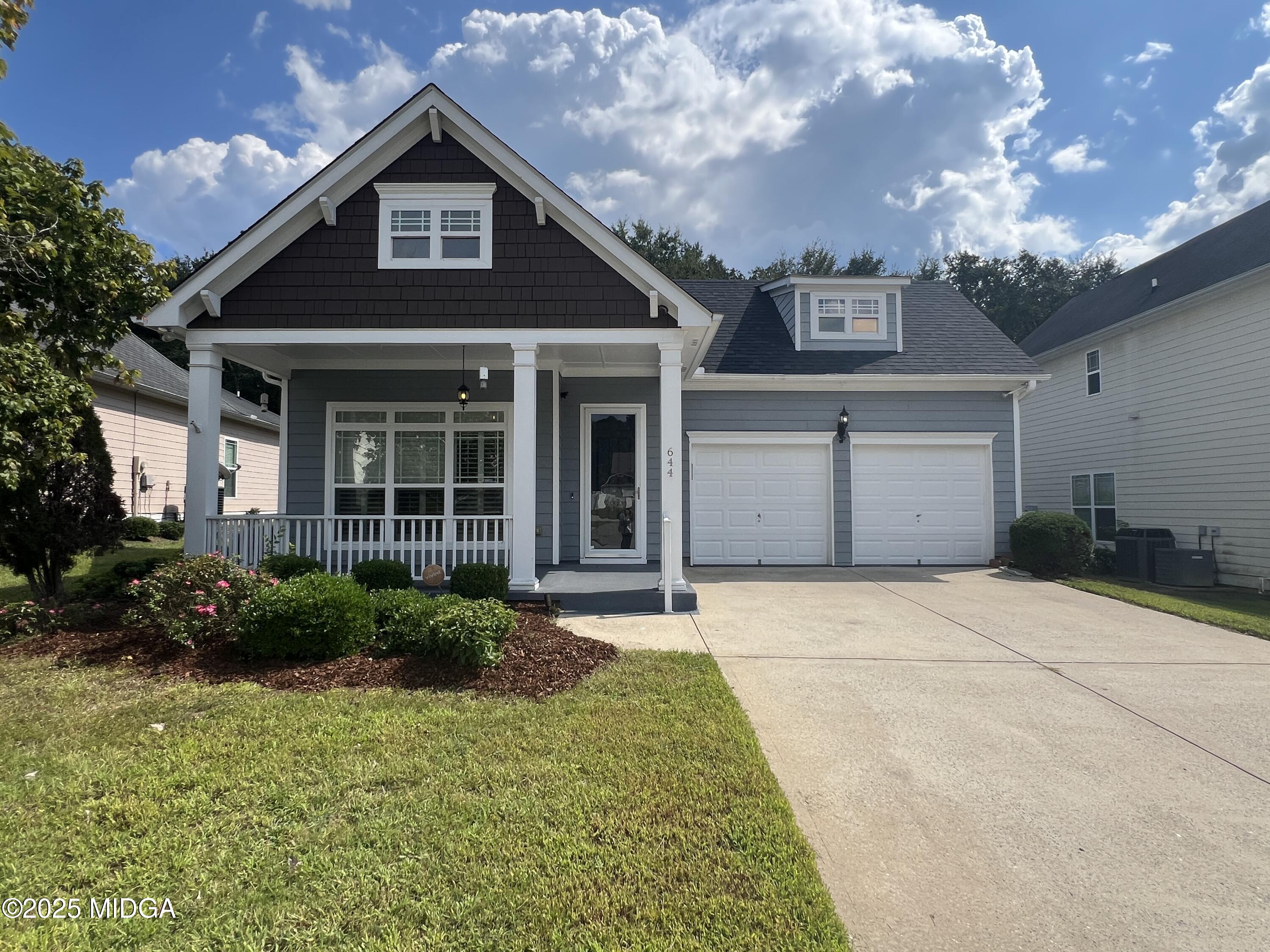 a front view of a house with garden