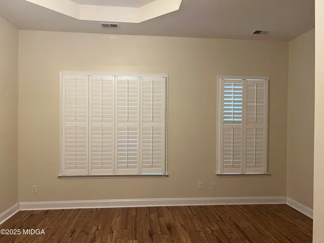 a view of a small space with wooden floor and a window