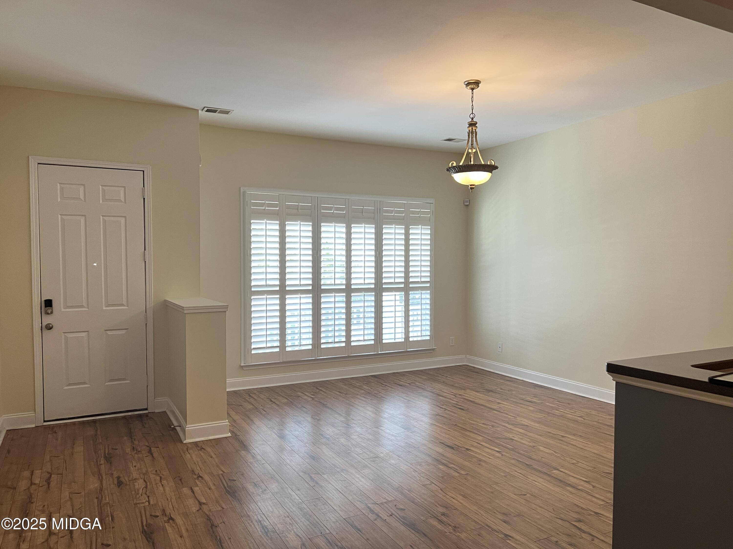 644 Ivy Brook Way Macon, GA 31210 - Photo 2 of 29 an empty room with wooden floor and windows