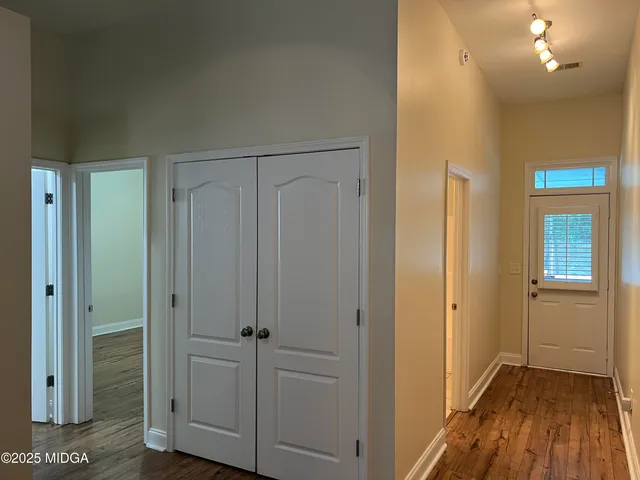 a view of a hallway with wooden floor