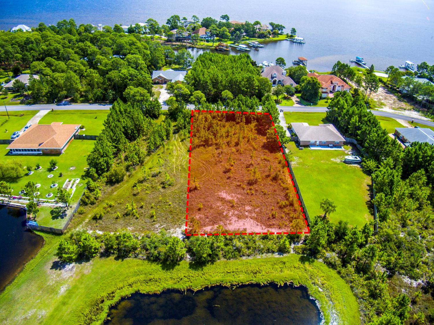 Lot 3 East Shipwreck Road Santa Rosa Beach, FL 32459 - Photo 1 of 26 an aerial view of a house with a yard and lake view