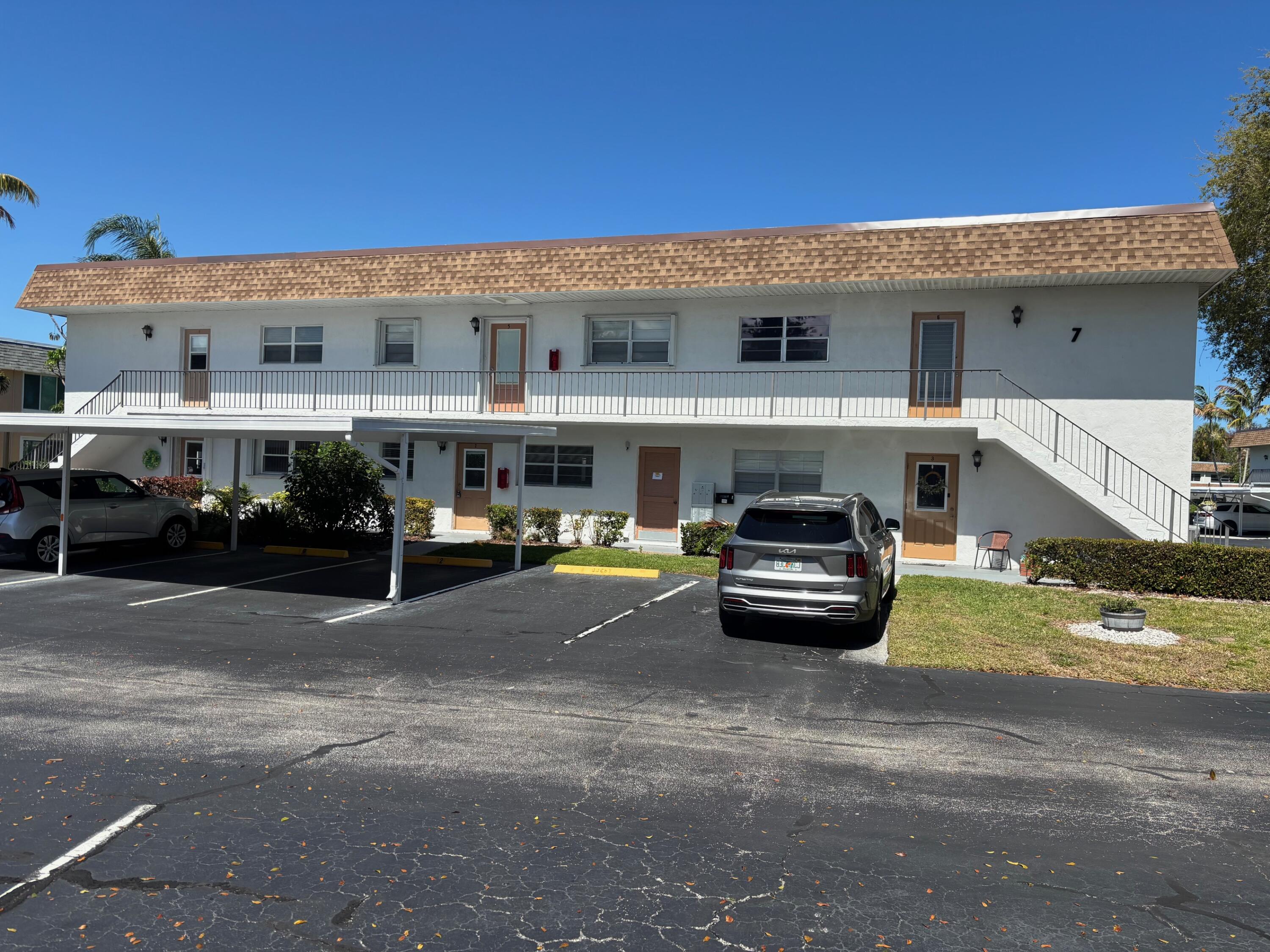2950 Southeast Ocean Boulevard, Unit 75 Stuart, FL 34996 - Photo 1 of 19 a car parked in front of a building