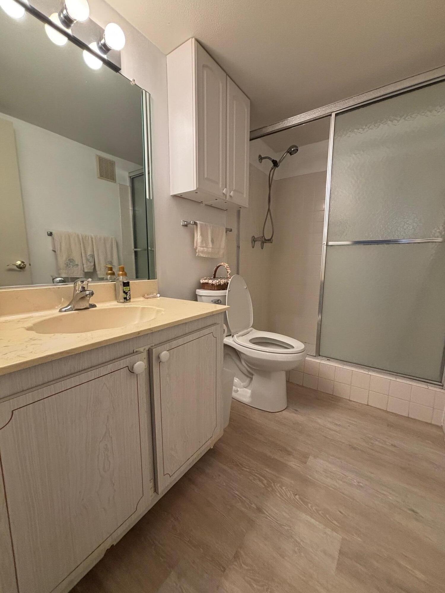 2950 Southeast Ocean Boulevard, Unit 75 Stuart, FL 34996 - Photo 11 of 19 a bathroom with a sink toilet and shower