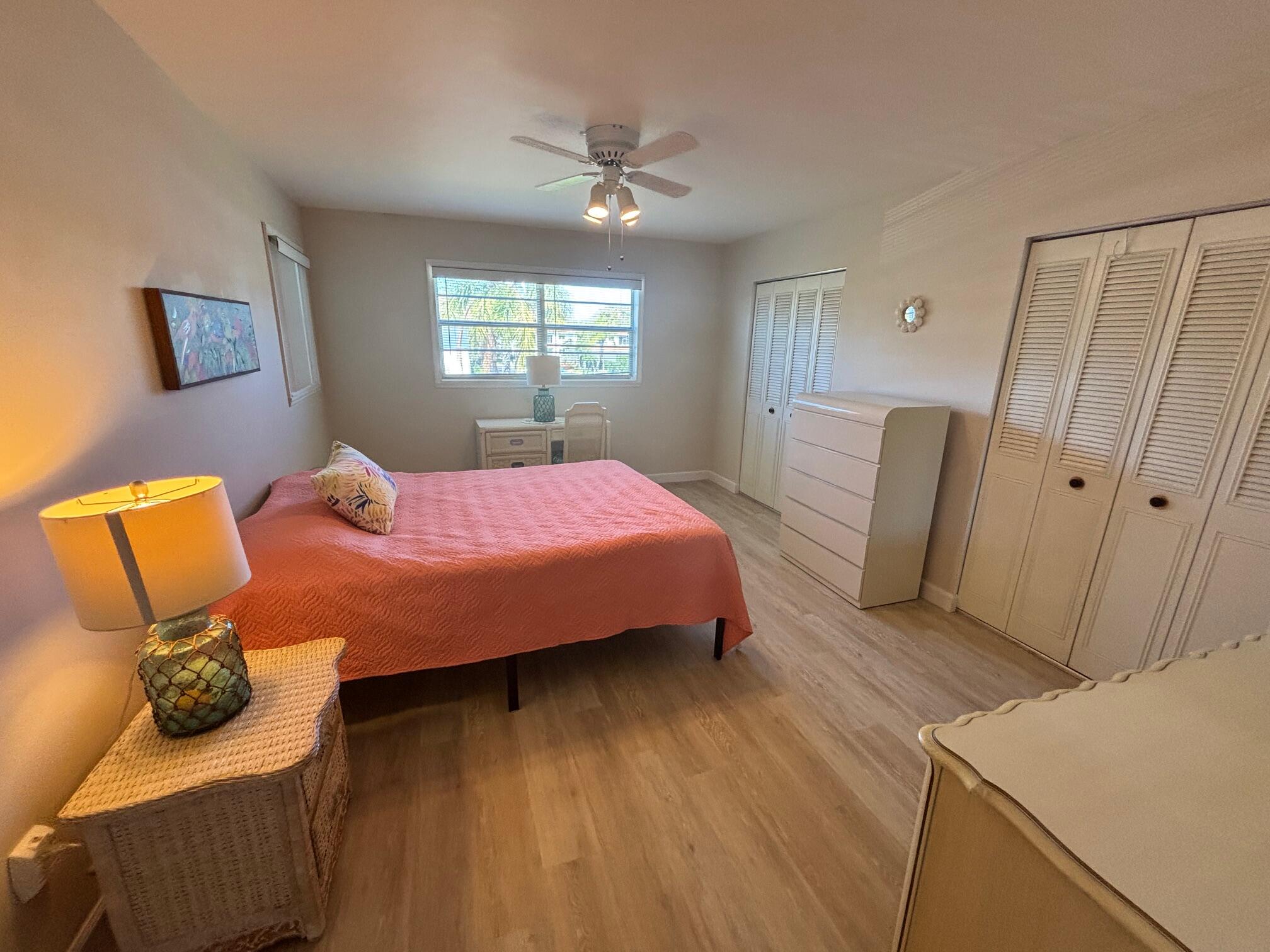 2950 Southeast Ocean Boulevard, Unit 75 Stuart, FL 34996 - Photo 12 of 19 a bedroom with a bed and wooden floor