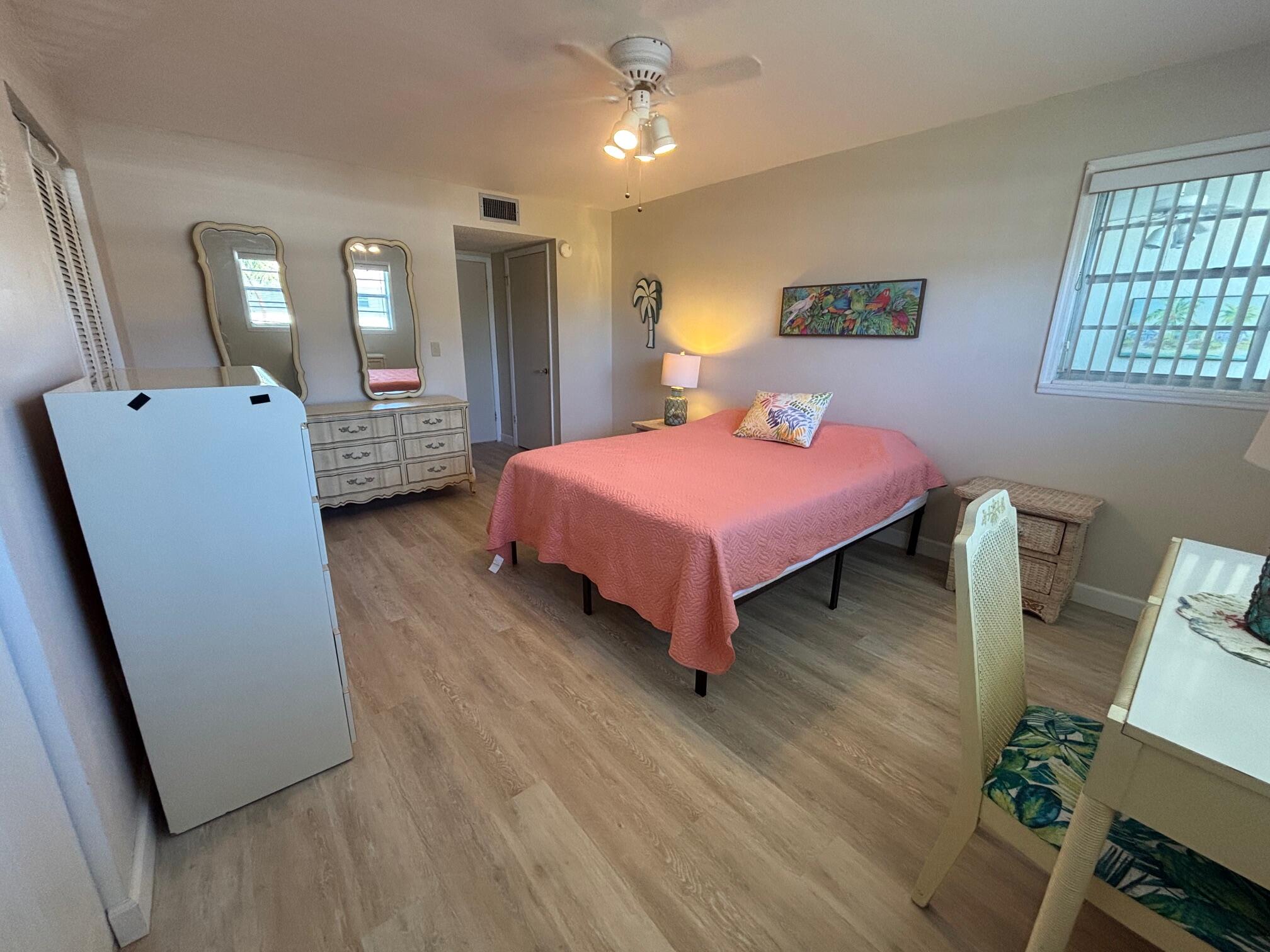 2950 Southeast Ocean Boulevard, Unit 75 Stuart, FL 34996 - Photo 13 of 19 a bedroom with a bed and a dresser