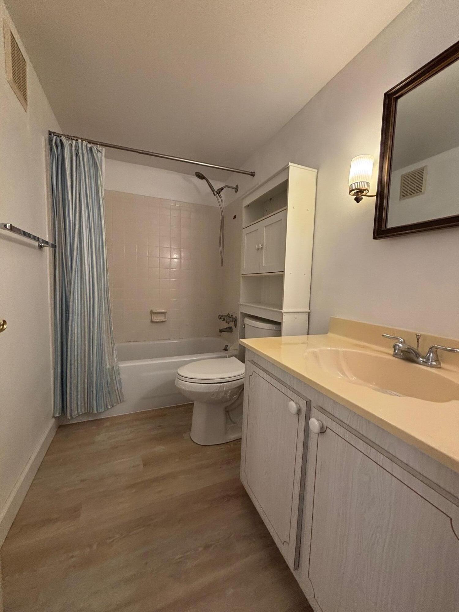 2950 Southeast Ocean Boulevard, Unit 75 Stuart, FL 34996 - Photo 14 of 19 a bathroom with a sink a toilet and mirror