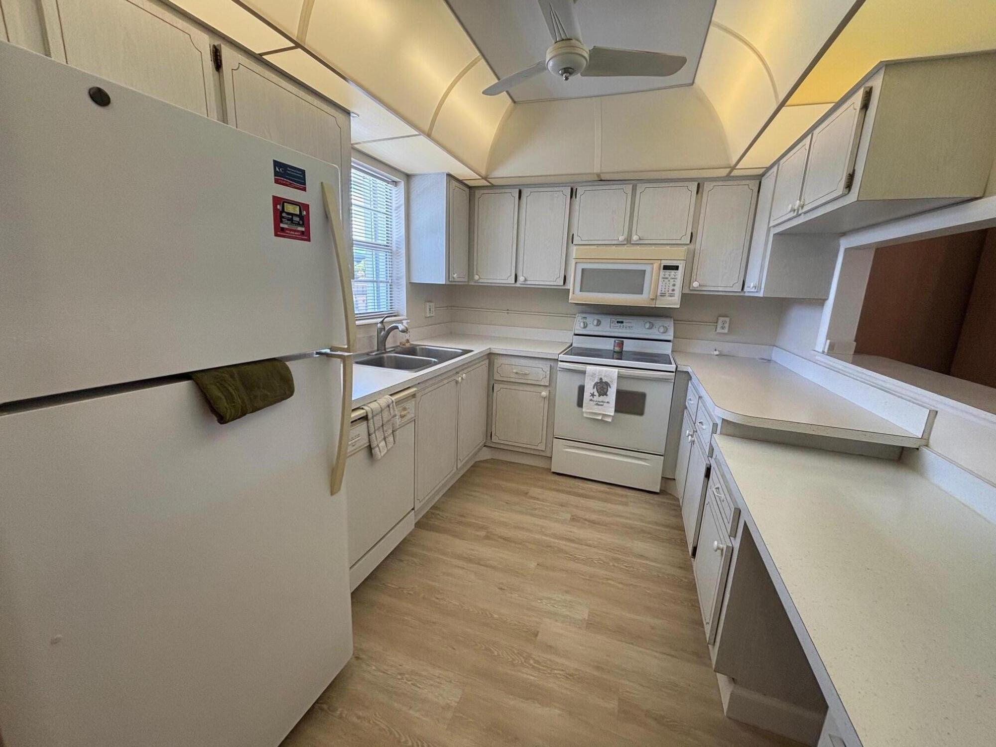 2950 Southeast Ocean Boulevard, Unit 75 Stuart, FL 34996 - Photo 2 of 19 a kitchen with stainless steel appliances granite countertop a stove a sink and a refrigerator