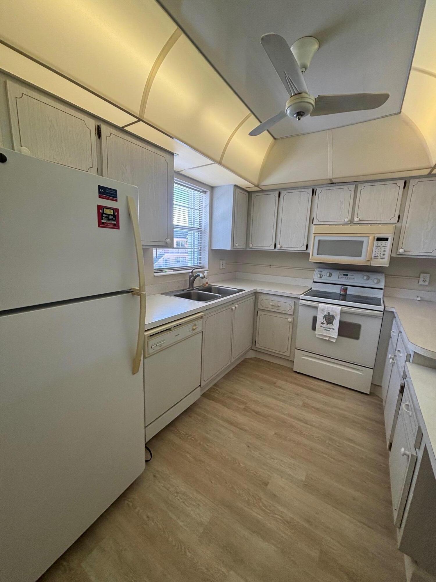 2950 Southeast Ocean Boulevard, Unit 75 Stuart, FL 34996 - Photo 4 of 19 a kitchen with stainless steel appliances granite countertop a sink and a refrigerator