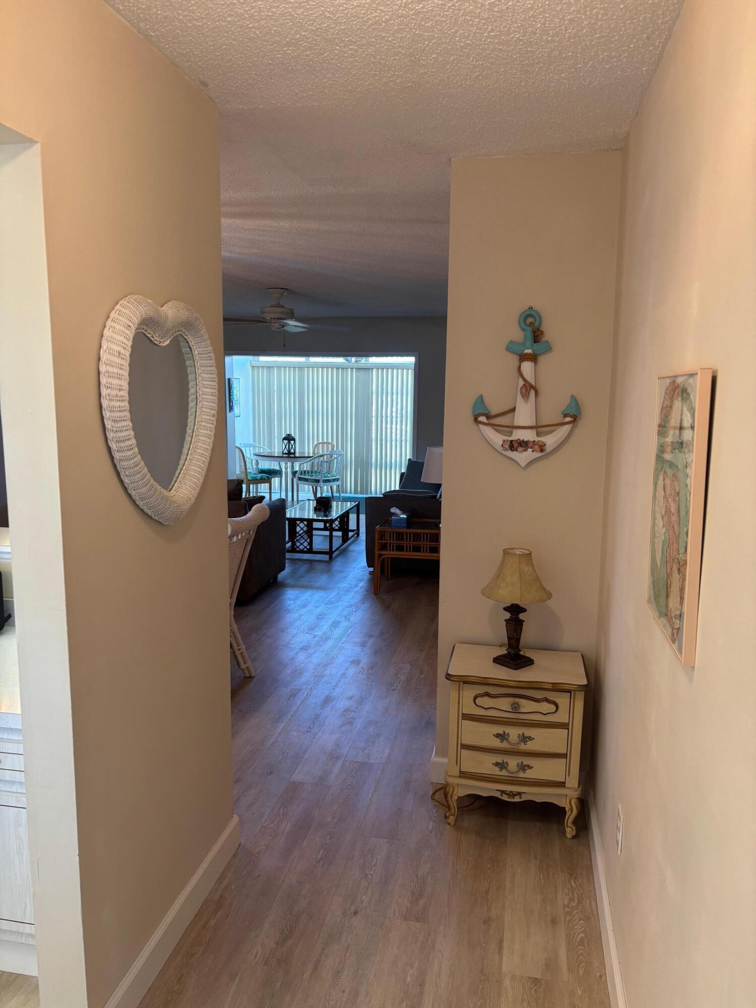 2950 Southeast Ocean Boulevard, Unit 75 Stuart, FL 34996 - Photo 5 of 19 a living room with furniture and a wooden floor