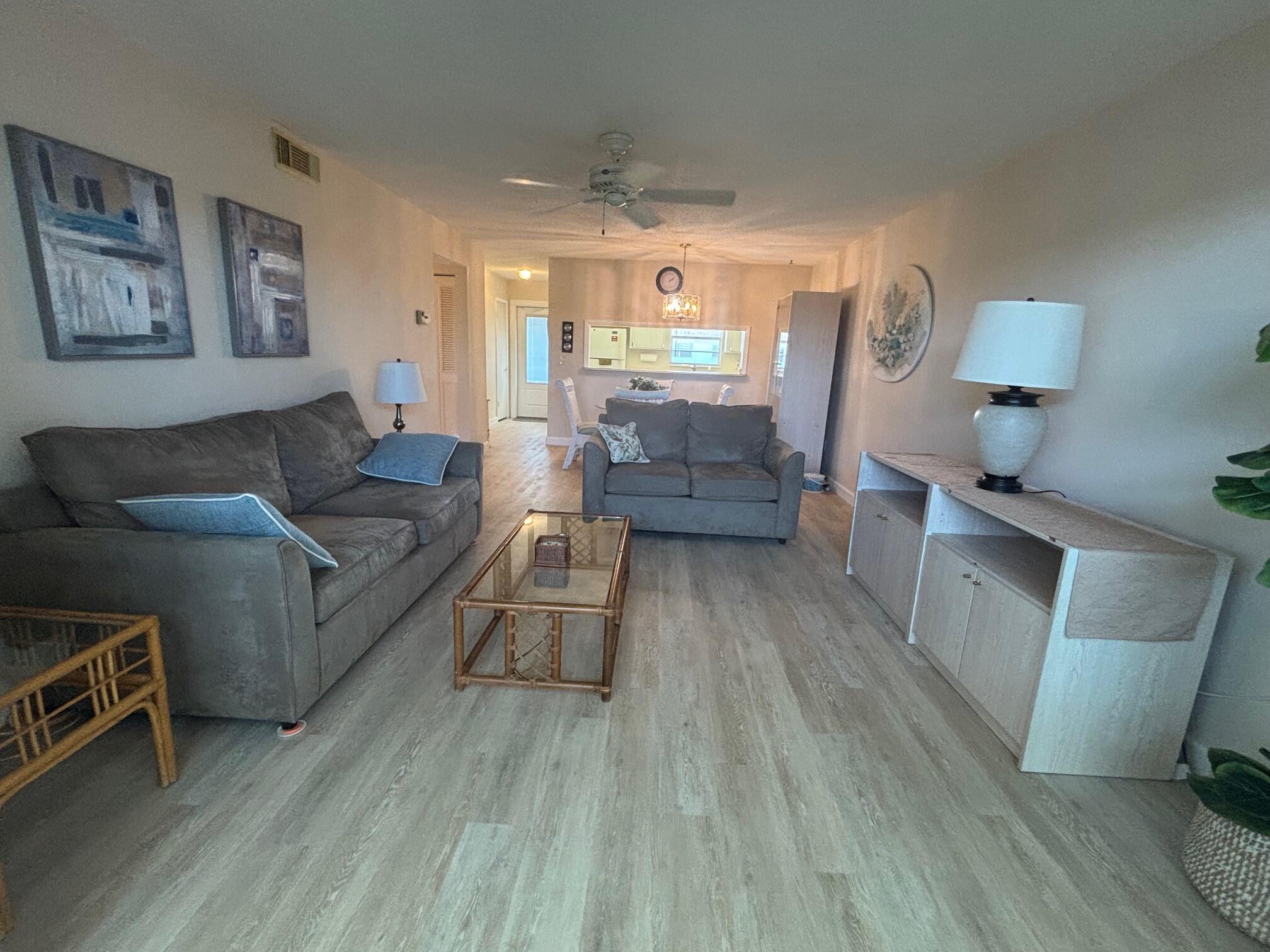 2950 Southeast Ocean Boulevard, Unit 75 Stuart, FL 34996 - Photo 7 of 19 a living room with furniture and a wooden floor