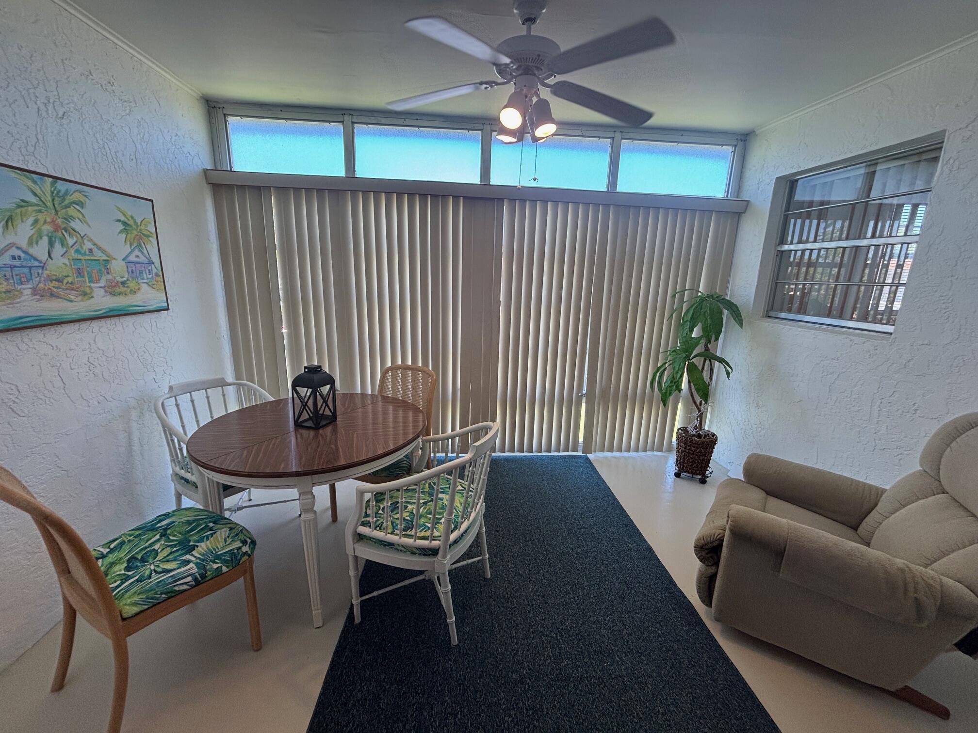2950 Southeast Ocean Boulevard, Unit 75 Stuart, FL 34996 - Photo 8 of 19 a backyard of a house with table and chairs
