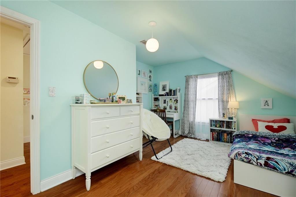 4412 Barrow Avenue, Unit B Austin, TX 78751 - Photo 19 of 28 a bedroom with a bed and wooden floor