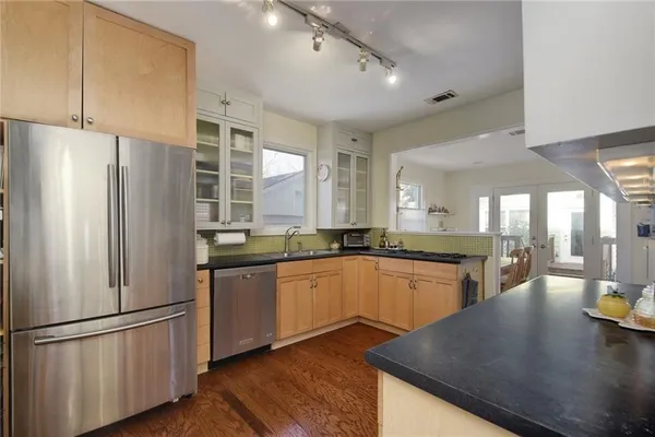a large kitchen with a sink and a large window
