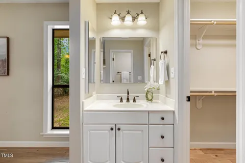 an empty room with wooden floor and ceiling fan