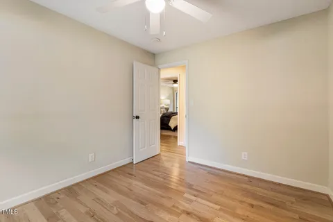 a bathroom with a granite countertop sink and a mirror with toilet