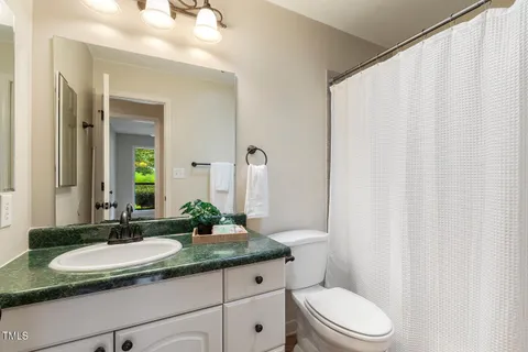 an empty room with wooden floor and ceiling fan