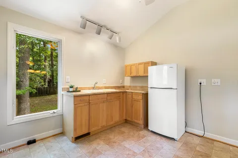 a view of a wooden chairs and table on the deck