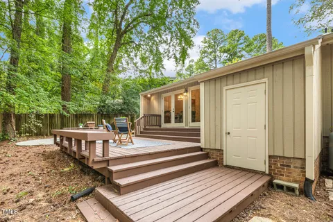 a view of a patio with chairs next to a yard