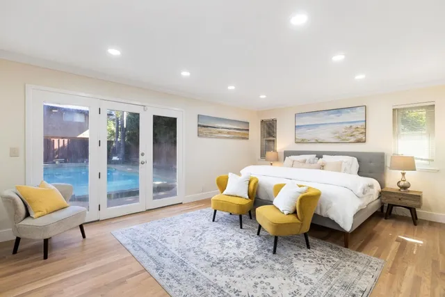 a spacious bedroom with a bed a couch and dresser