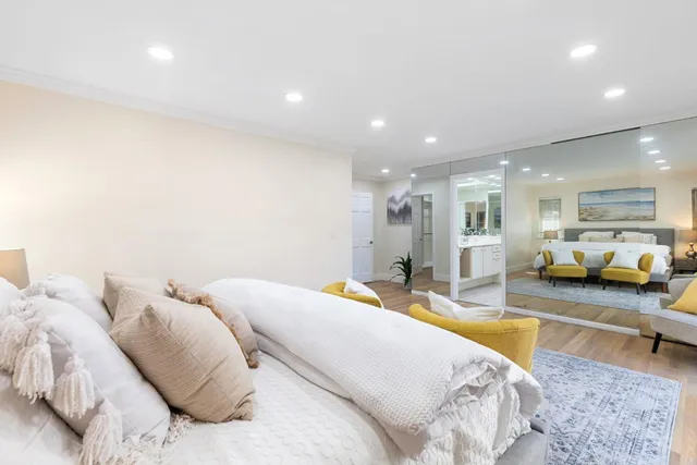 a bed room with a bed and a view of living room