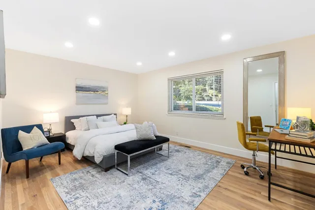 a bedroom with furniture and a rug