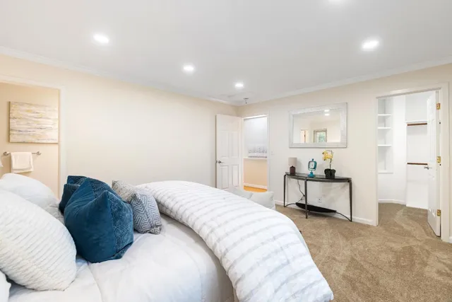 a spacious bedroom with a bed and a desk