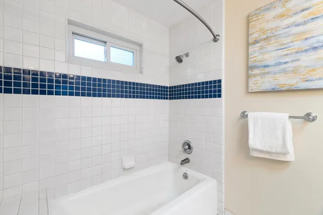 a bathroom with a bathtub and shower