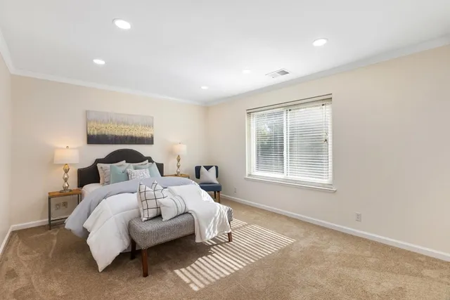 a bedroom with bed and a window