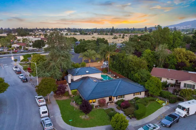 an aerial view of a house with garden space and street view
