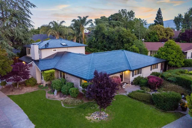 a view of a house with a yard and garden
