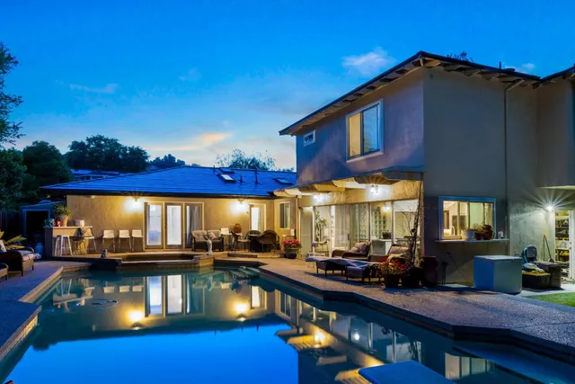 a view of a swimming pool and lounge chairs