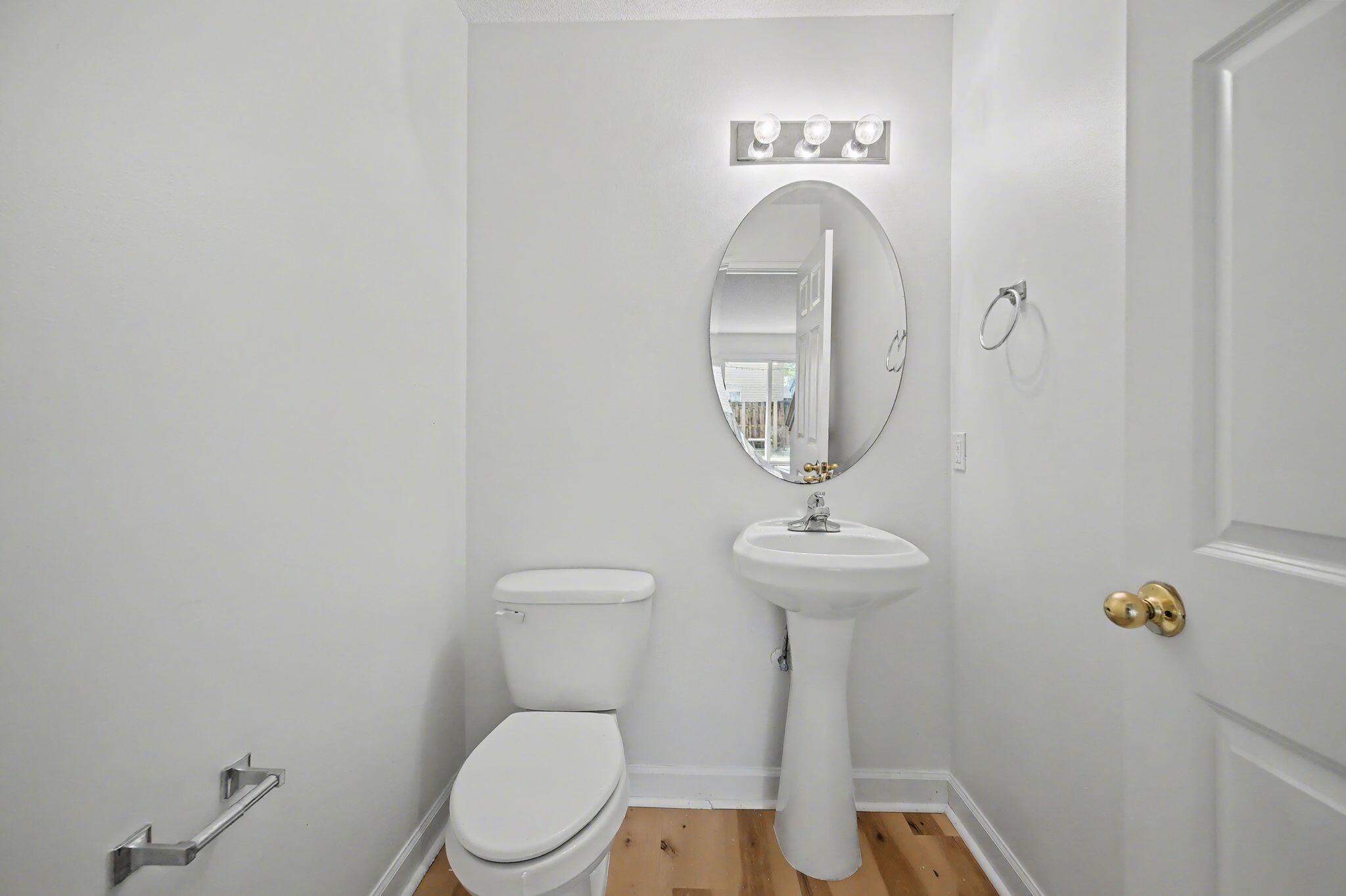 28 3rd Street Shalimar, FL 32579 - Photo 13 of 31 a bathroom with a toilet a sink and a mirror