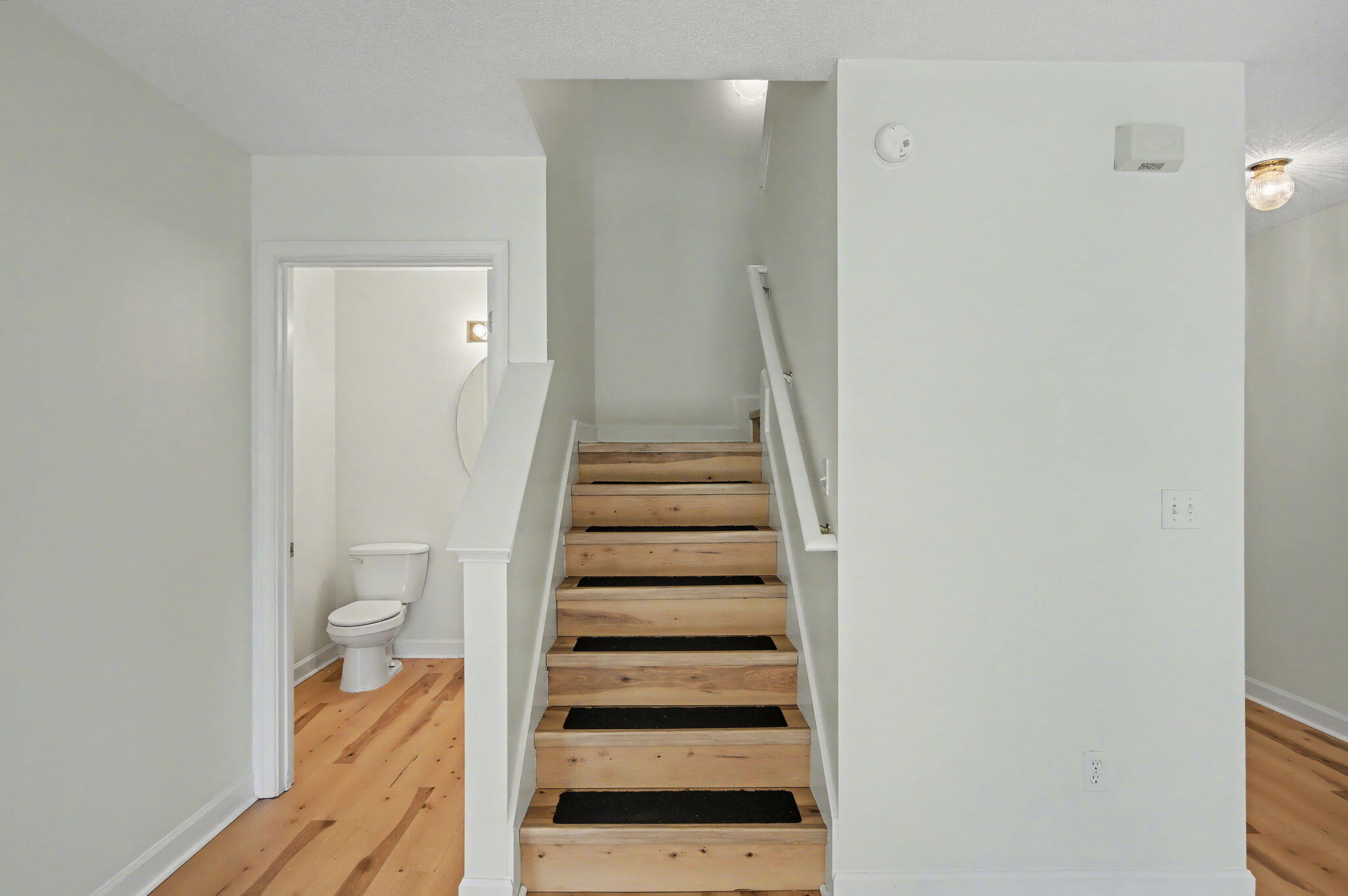 28 3rd Street Shalimar, FL 32579 - Photo 14 of 31 a view of a hallway with wooden floor and staircase