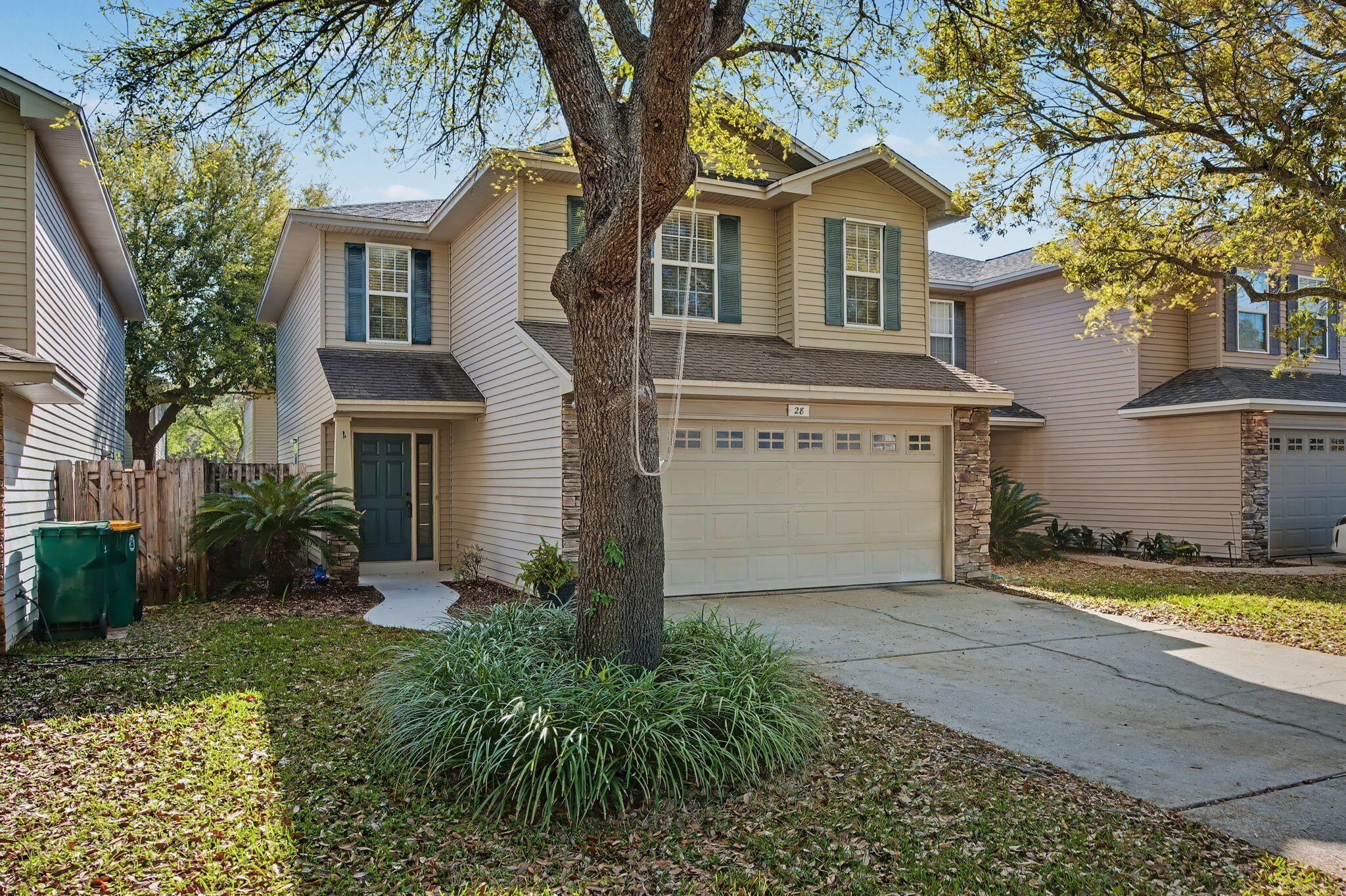 28 3rd Street Shalimar, FL 32579 - Photo 2 of 31 a front view of a house with a yard and garage