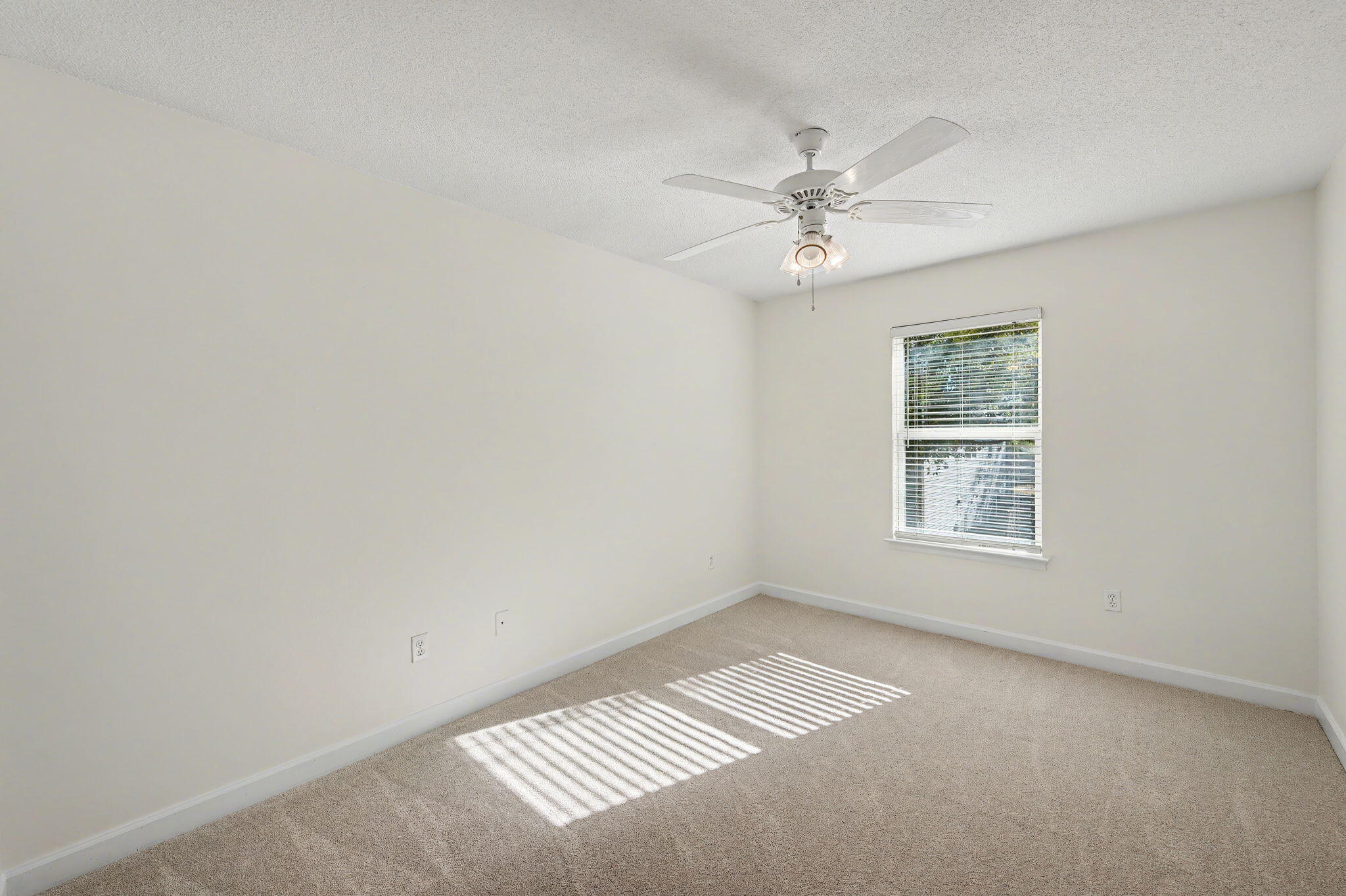 28 3rd Street Shalimar, FL 32579 - Photo 23 of 31 an empty room with chandelier fan and windows