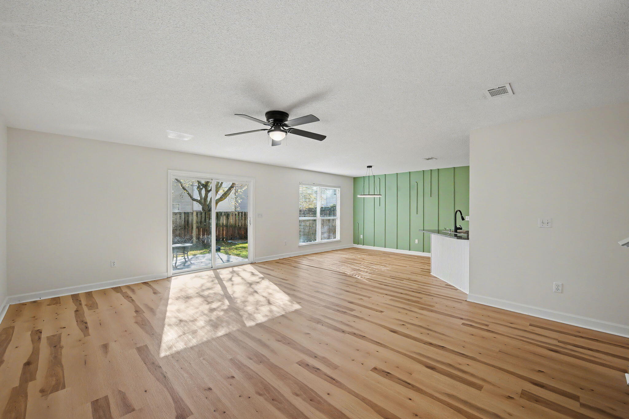 28 3rd Street Shalimar, FL 32579 - Photo 5 of 31 a view of an empty room with wooden floor and a window