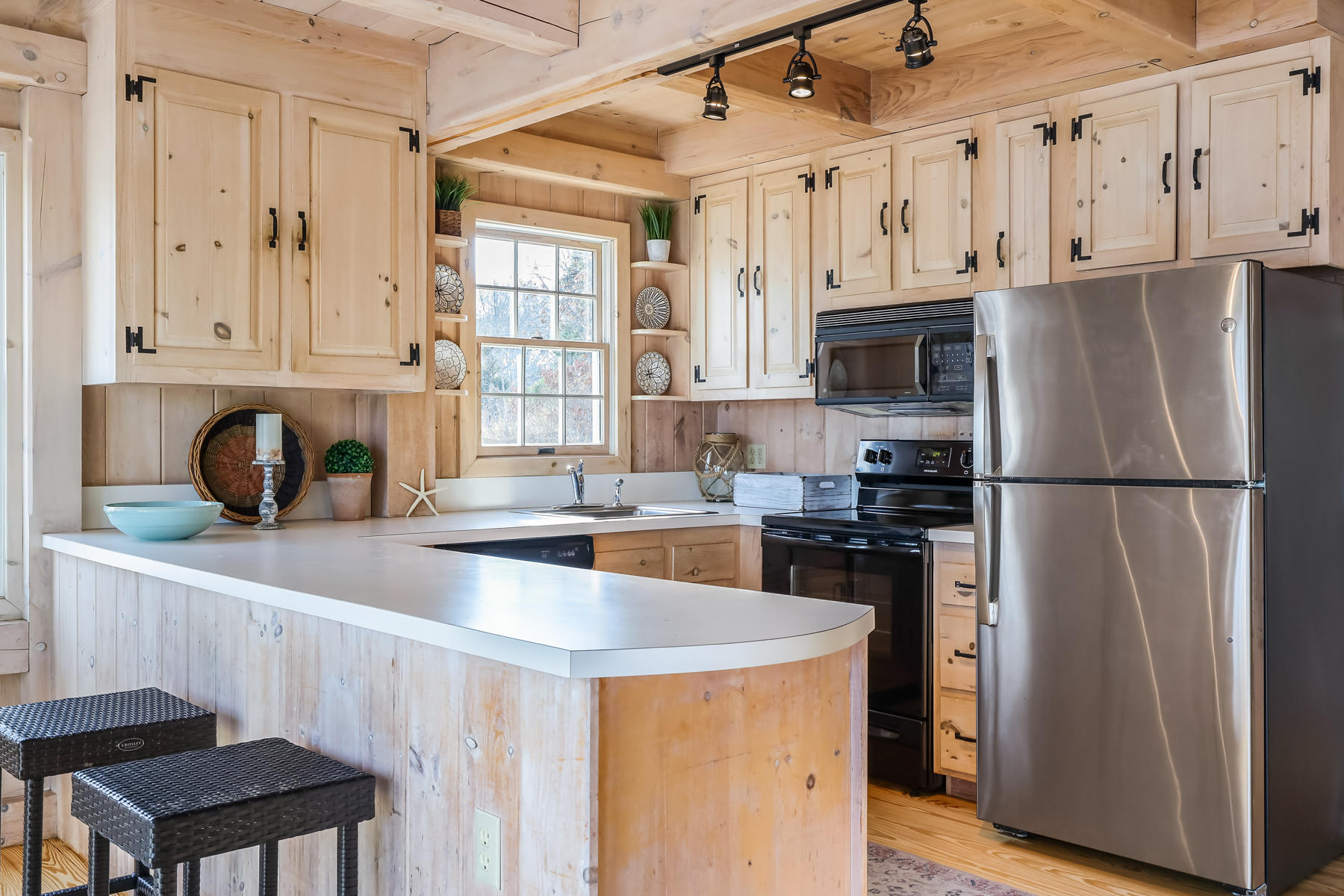 100 Lawton Road Eastham, MA 02642 - Photo 12 of 62 a kitchen with stainless steel appliances granite countertop a refrigerator a sink dishwasher a stove with wooden cabinets