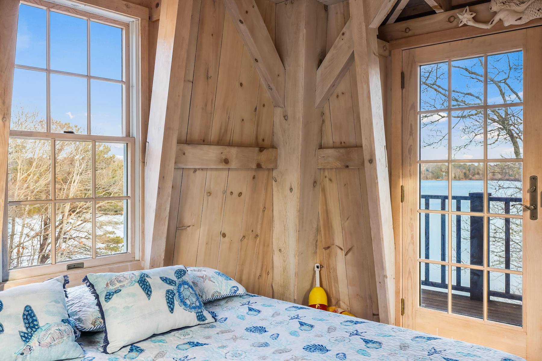 100 Lawton Road Eastham, MA 02642 - Photo 46 of 62 a bedroom with a large window and a bed