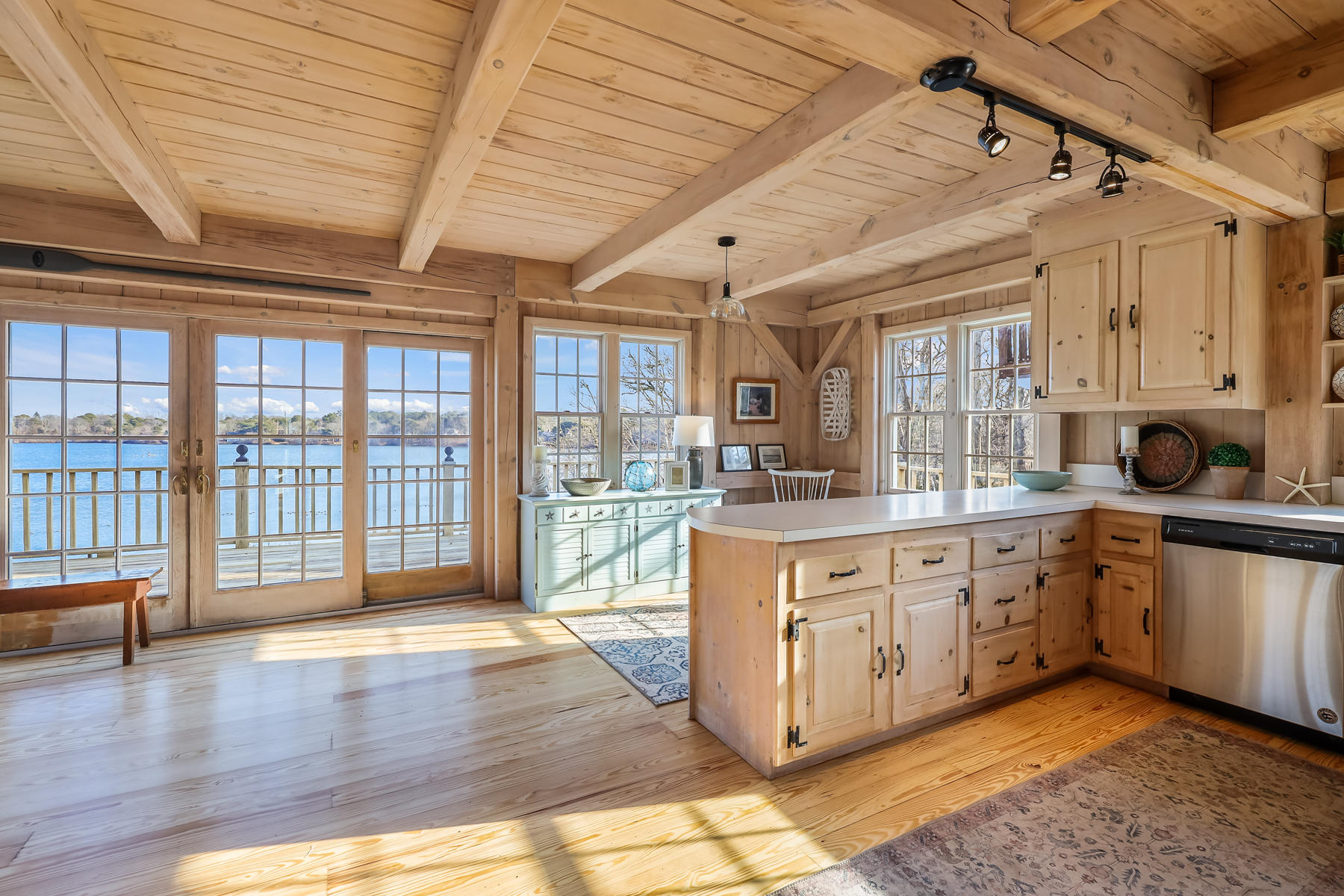 100 Lawton Road Eastham, MA 02642 - Photo 6 of 62 a open kitchen with stainless steel appliances granite countertop a stove a sink and a granite countertops with cabinets