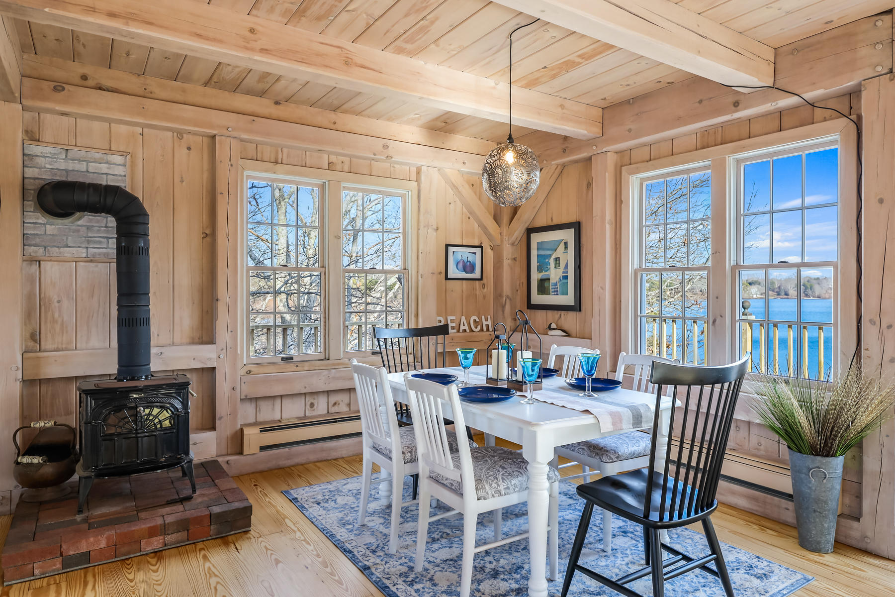 100 Lawton Road Eastham, MA 02642 - Photo 7 of 62 a view of a dining room with furniture wooden floor and chandelier