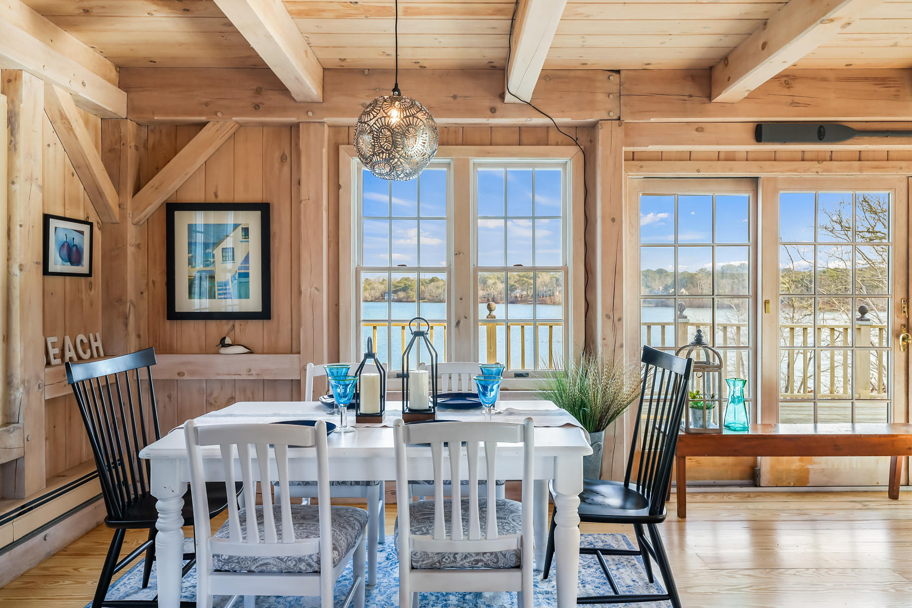 100 Lawton Road Eastham, MA 02642 - Photo 8 of 62 a view of a dining room with furniture a chandelier and wooden floor