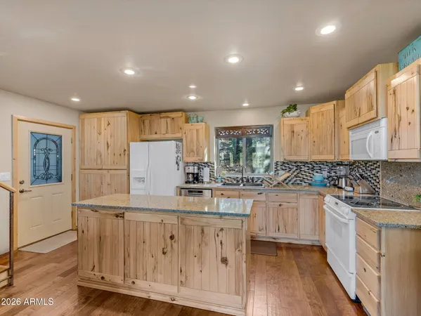 a kitchen with counter top space sink and refrigerator