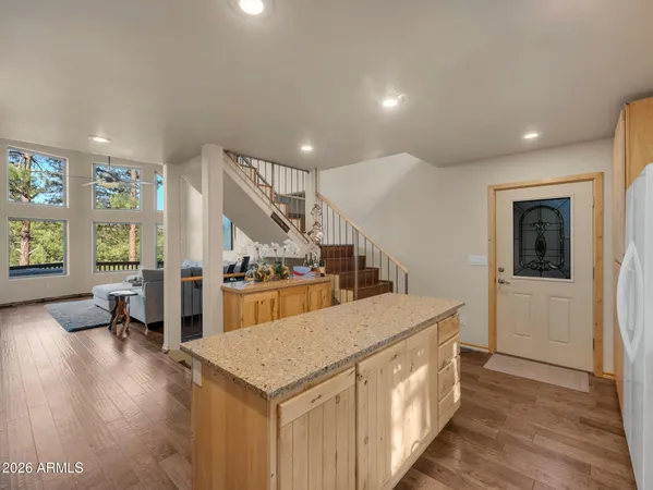 a kitchen with a sink a counter top space and stainless steel appliances