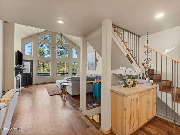 a view of a livingroom with furniture wooden floor and windows