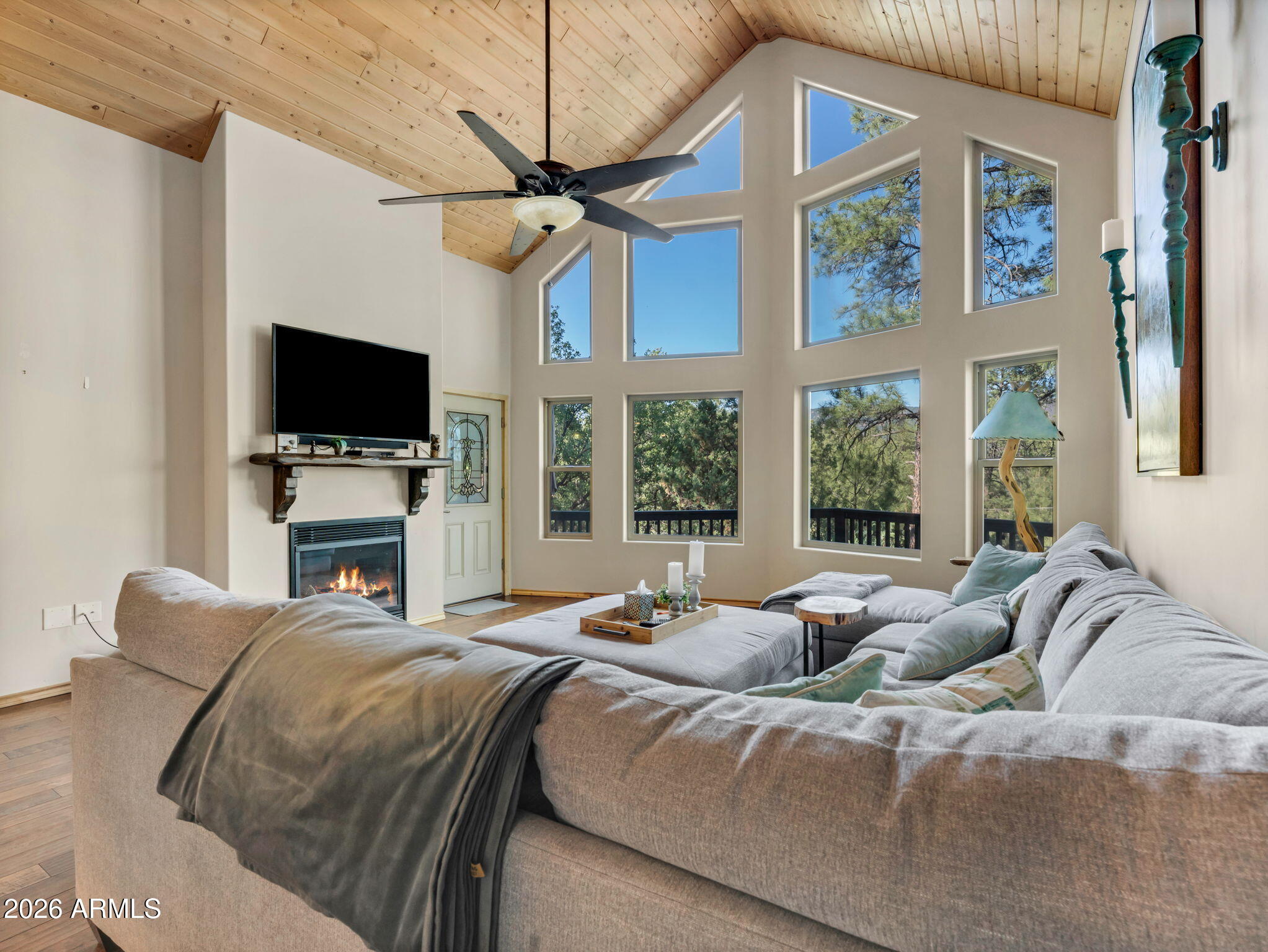 6829 Robbin Lane Pine, AZ 85544 - Photo 17 of 44 a bedroom with a bed television and a large window